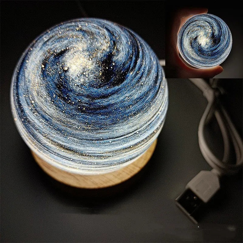 USB-powered planet night light with three-colour electrodeless dimming, modern minimalist design, 80mm diameter sphere on a base, choice of 12 light colour themes including aurora, starry sky and sunset glow for bedroom decor.