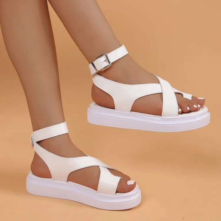 Women's white Roman-style sandals with thick composite sole, outer lace loops, and adjustable buckle fastening