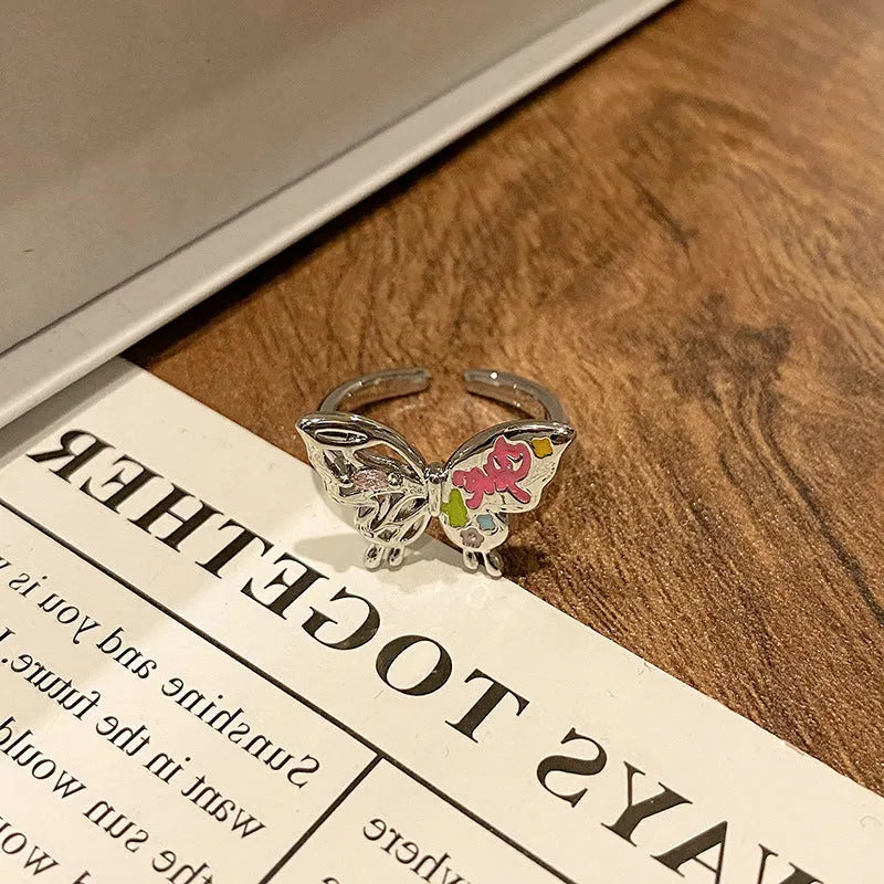 Copper women's ring with Chinese butterfly design and adjustable open loop.
