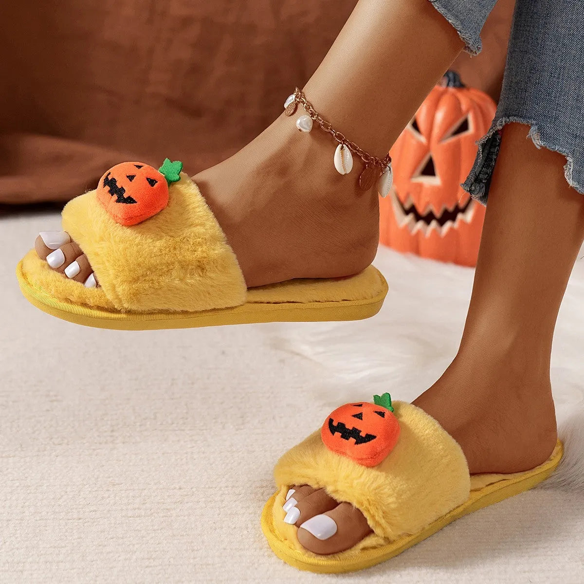 Yellow Halloween pumpkin plush open-toe slippers with synthetic fur and a light grey PVC anti-slip sole.