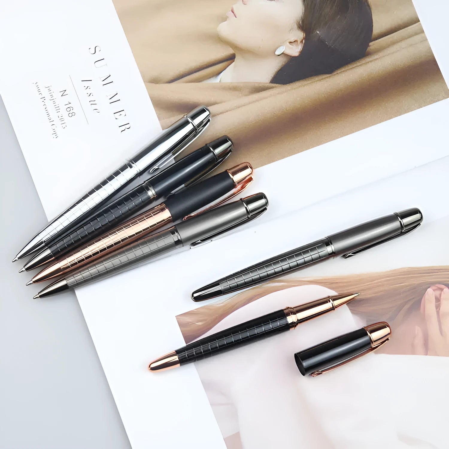 Gun grey metal rollerball pen with a metal barrel on a flat surface.