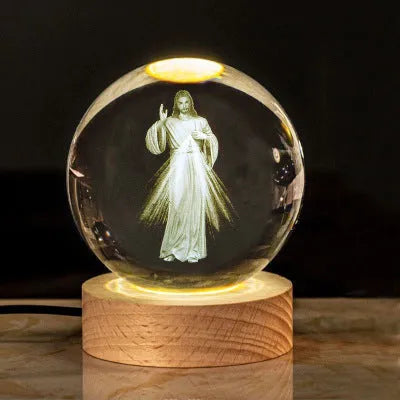 White crystal ball ornament with solid wood warm light base, showing purity engravings like Cross and Maria for desk decor