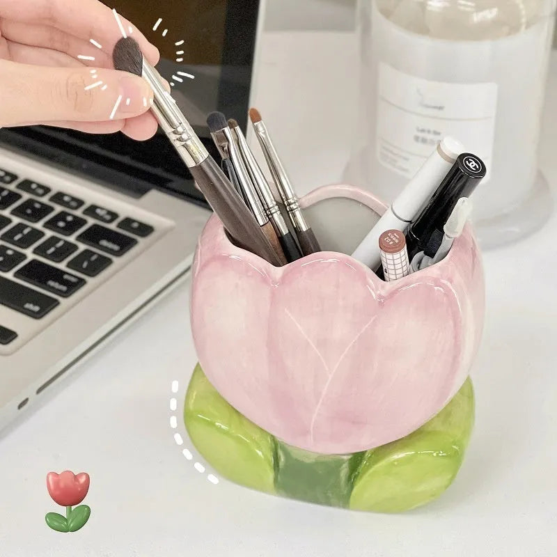 Ceramic floral pen holder showing blue flowers pattern, measuring 11.8cm wide by 10cm high