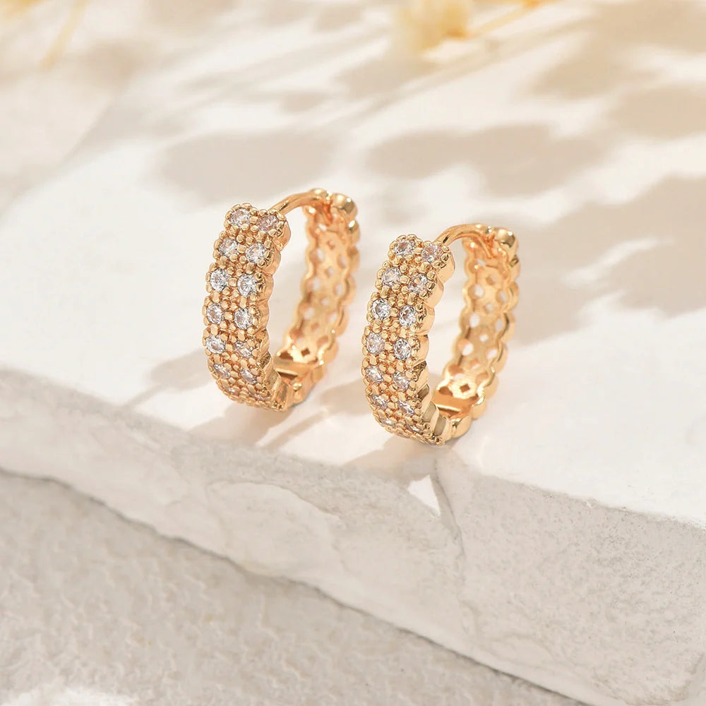 Copper geometry ear studs with round, dot, and ring elements in a unisex design.