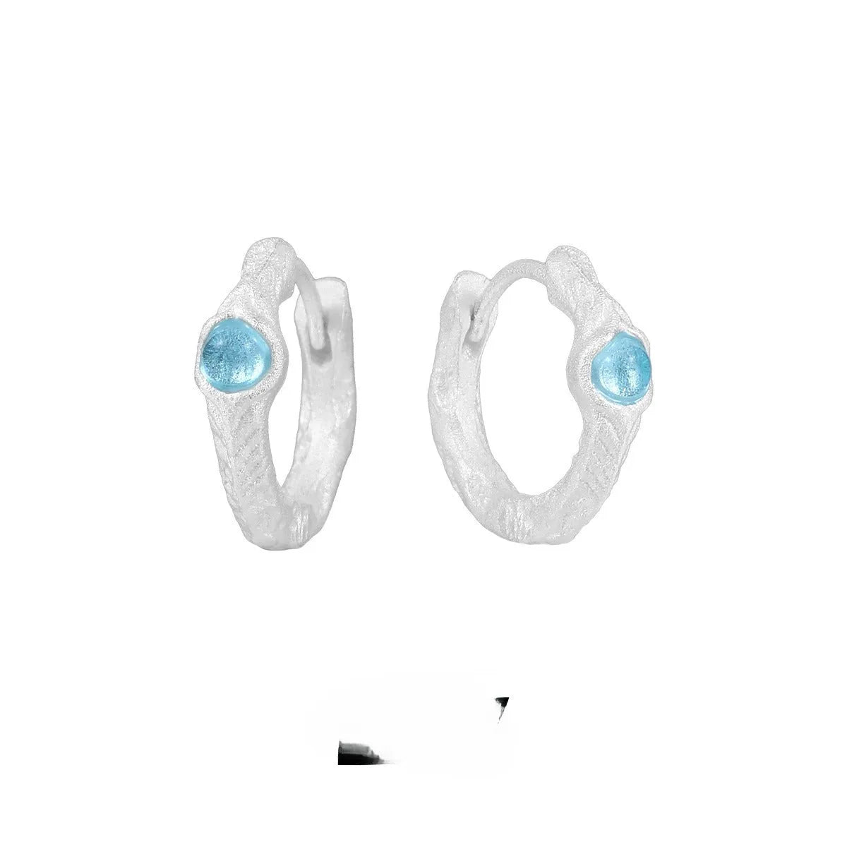 A pair of geometric round ear clips made from 925 silver with a burnt silver electroplated finish.