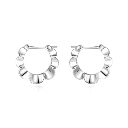 A pair of round, polished sterling silver geometric stud earrings on a plain background.