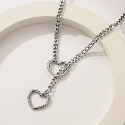 Stainless steel lariat heart necklace with heavy ring and Cuban chain in multiple finishes