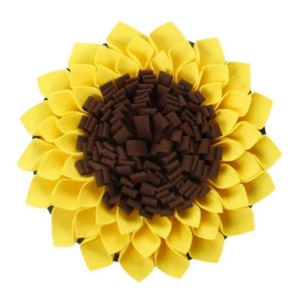 Yellow sunflower-shaped dog snuffle mat for slow feeding and nosework training on a floor.