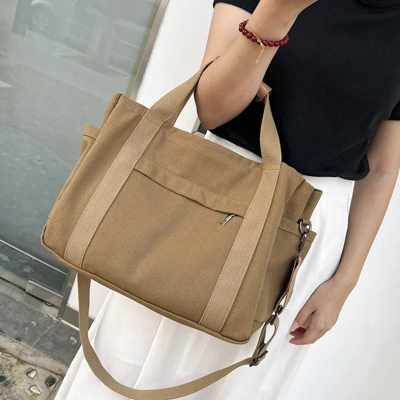 Army Green canvas tote bag showing open top with internal laptop pocket and organisers.