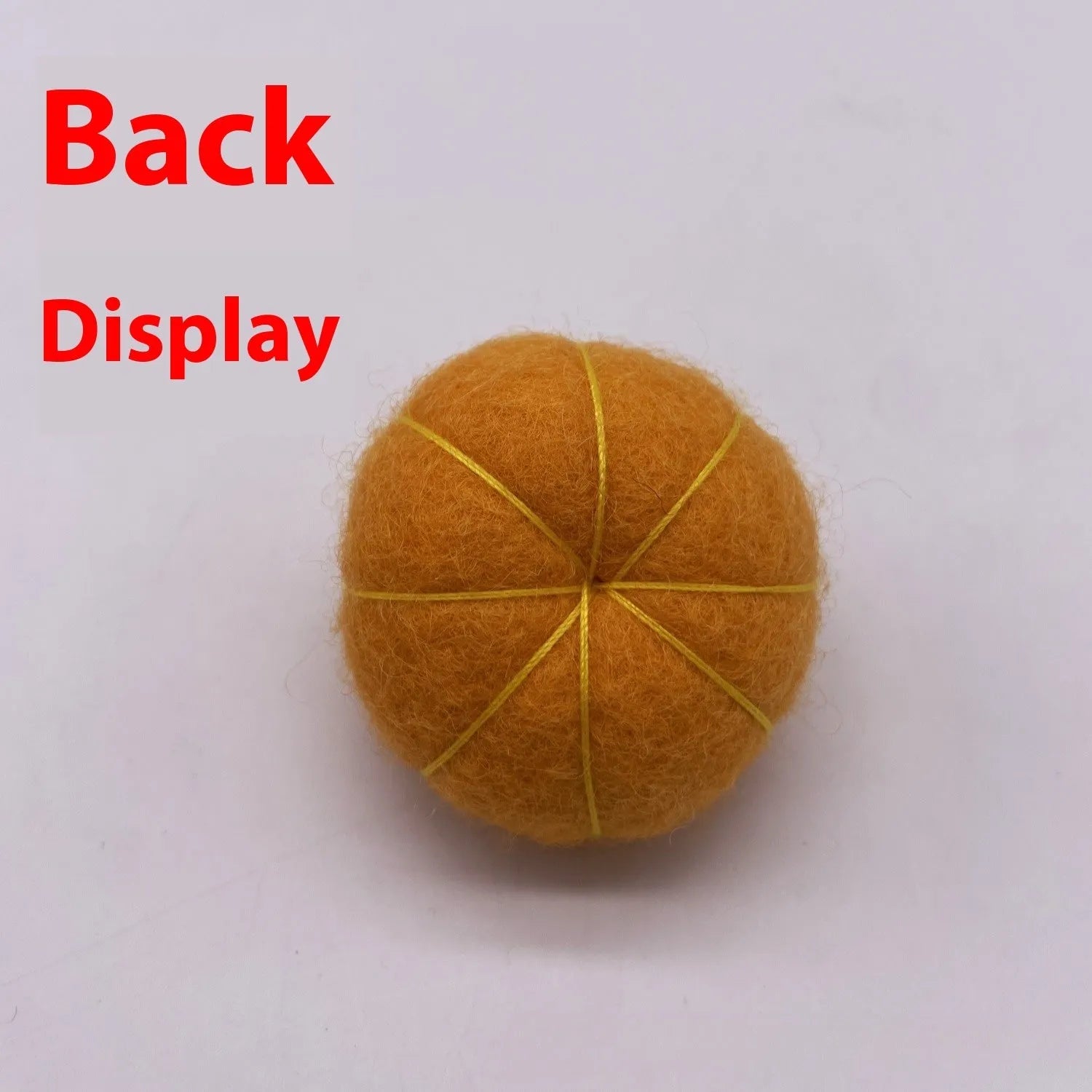 Wool felt pumpkin ornaments in various colours for doll decoration and craft projects.