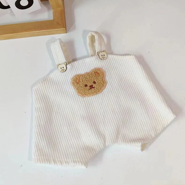 30cm doll clothing collection showing multiple outfit pieces including hooded jackets, sweaters, and suspender pants