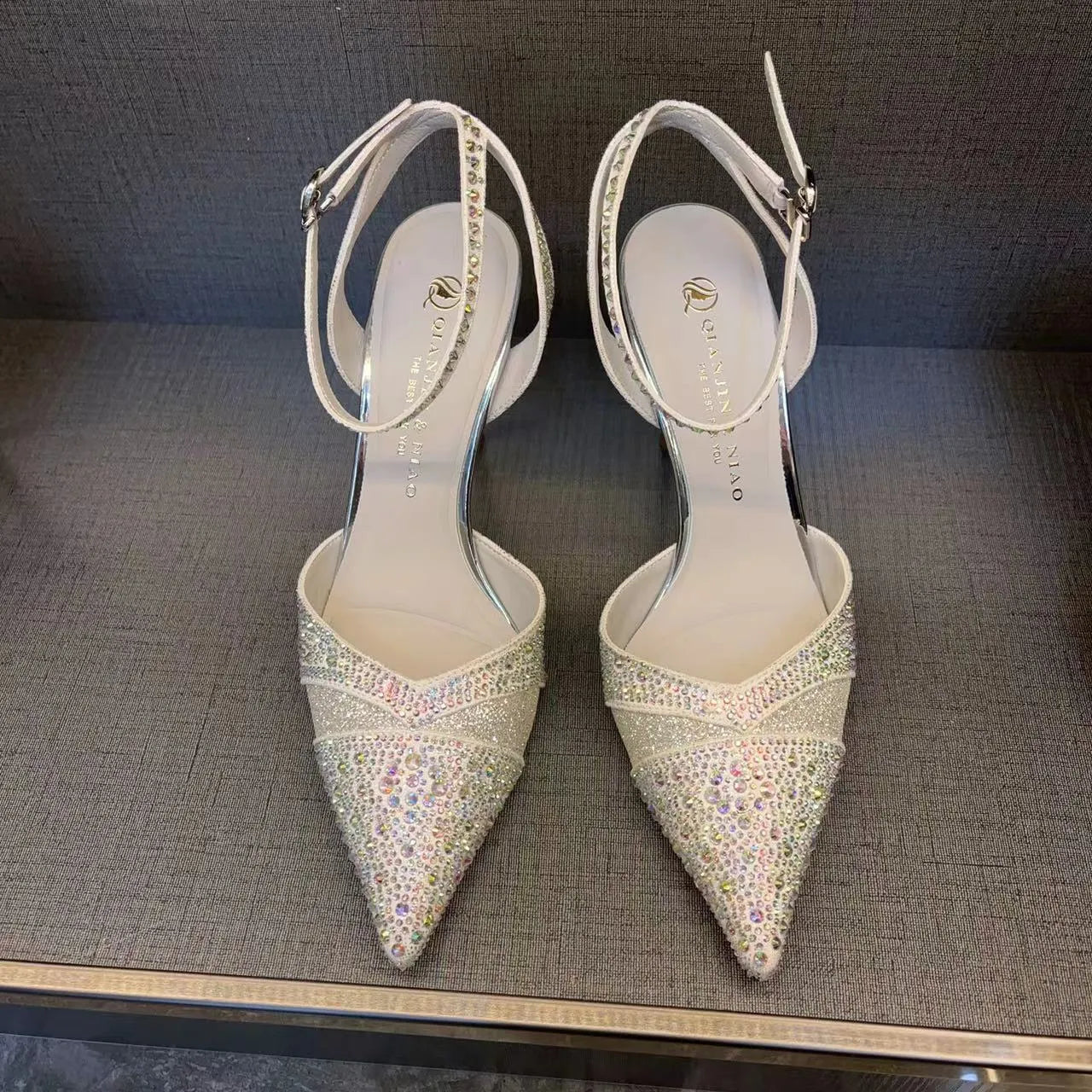 Women's hollow high heels with red sole, stiletto heel, and pointed toe in silver or black colours