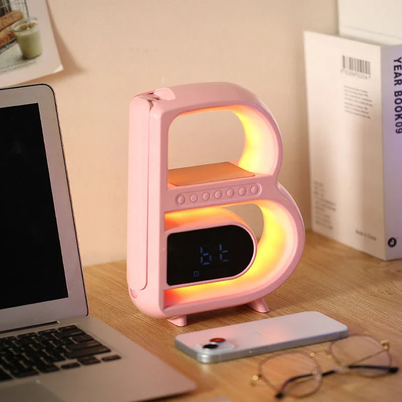 B-shaped Bluetooth speaker with wireless charging, adjustable lighting, and alarm clock functionality