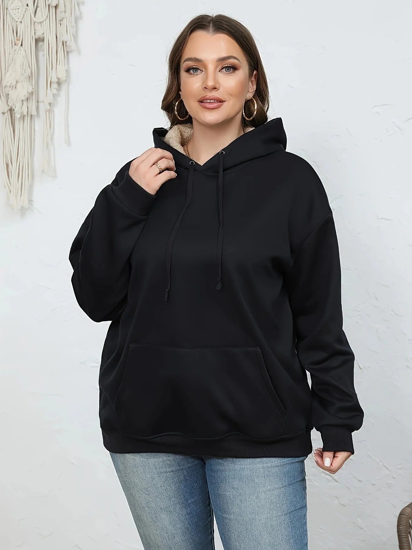 Women's loose fit hooded sweater in thick grey polyester fleece with 3D pattern and front pockets.