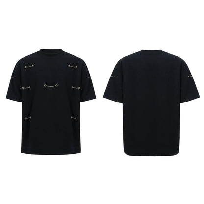 Black padded shoulder T-shirt with metal chain detail on model, showing short sleeves and round neck.