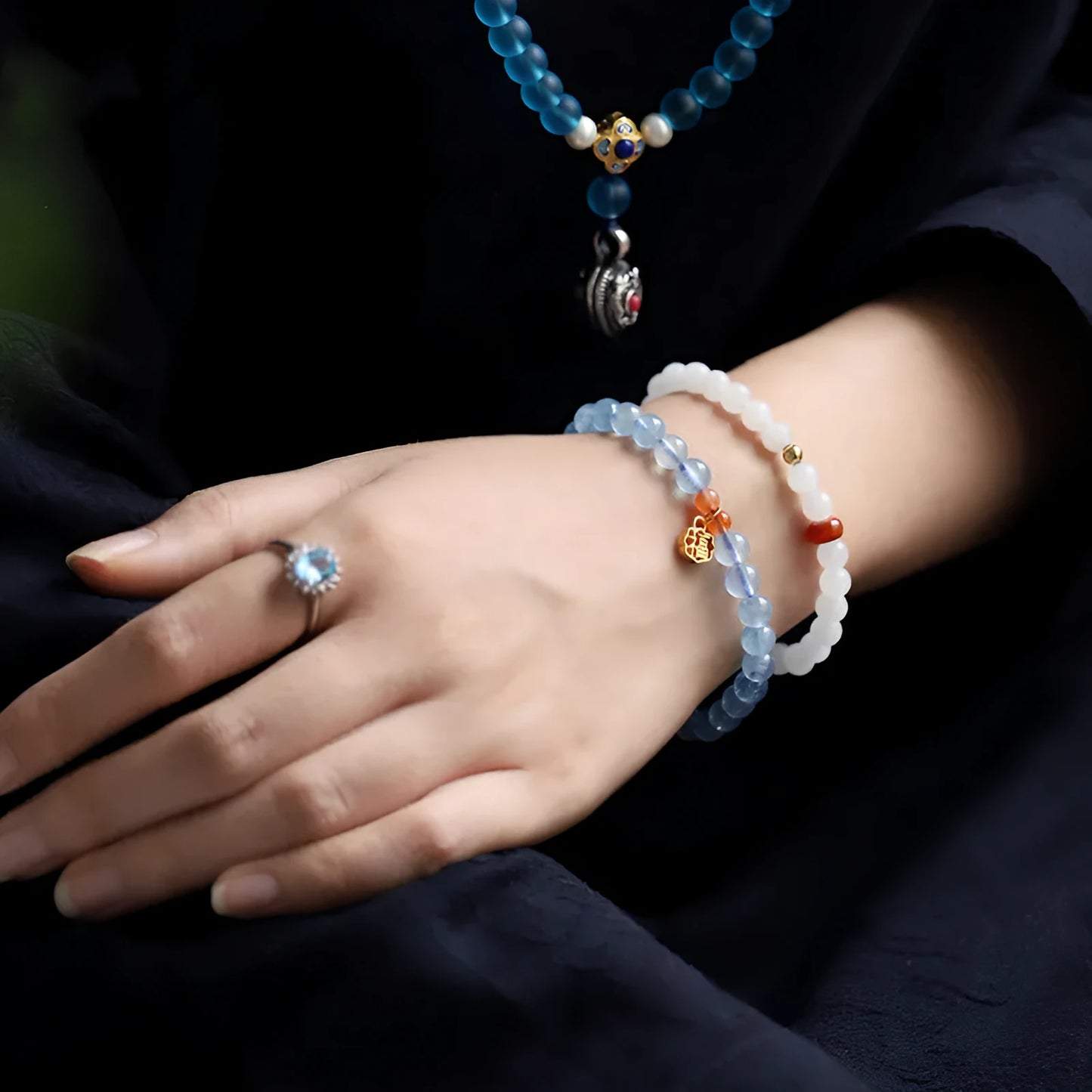 Ice translucent aquamarine crystal bracelet with 8mm round beads and sequin details on a wrist.