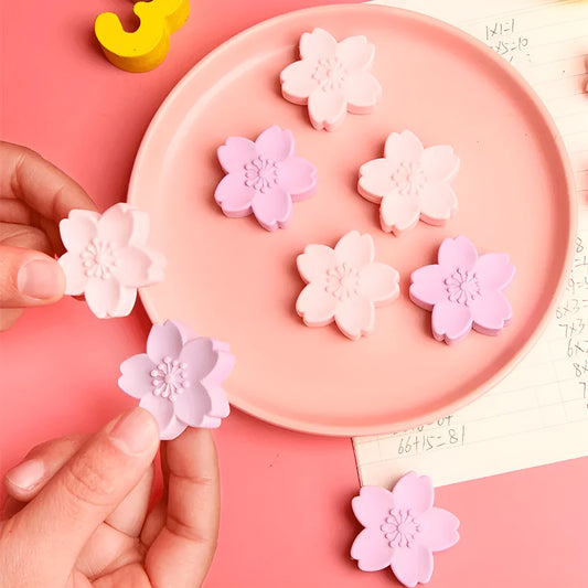 Assortment of cherry blossom designed erasers in various colours arranged in bulk packaging