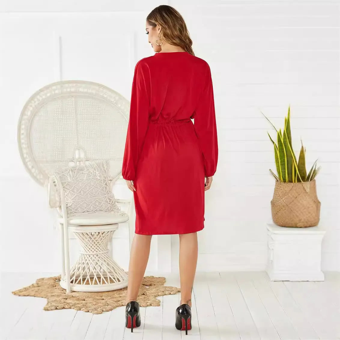 A-line mid-length dress with elastic waist, cinched belt, and long sleeves in solid black or red colour