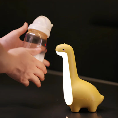 Dinosaur-shaped children's night light in lemon yellow with USB charging cable and 3000K warm white illumination