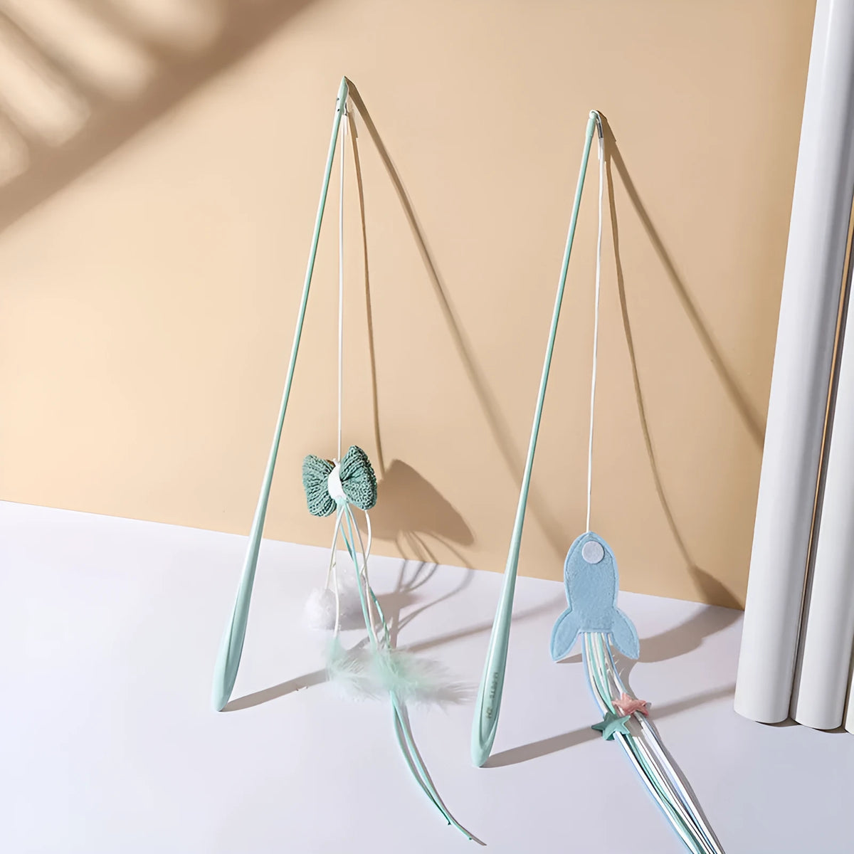 Blue and green long pole cat toy with feather attachments for interactive indoor play with kittens