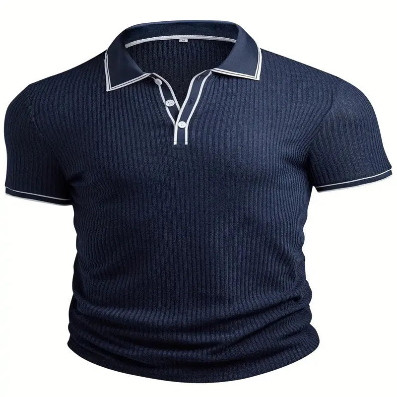 A man wearing a loose-fit, striped, short-sleeved polo shirt in a dark colour.