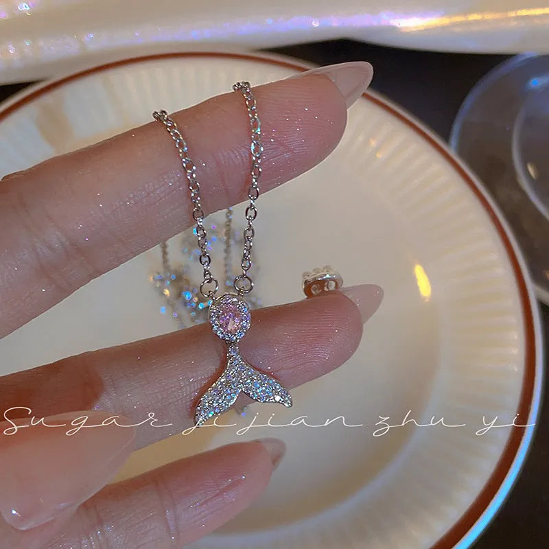 Women's sterling silver fishtail pendant necklace on adjustable O-ring chain, showing geometric design.