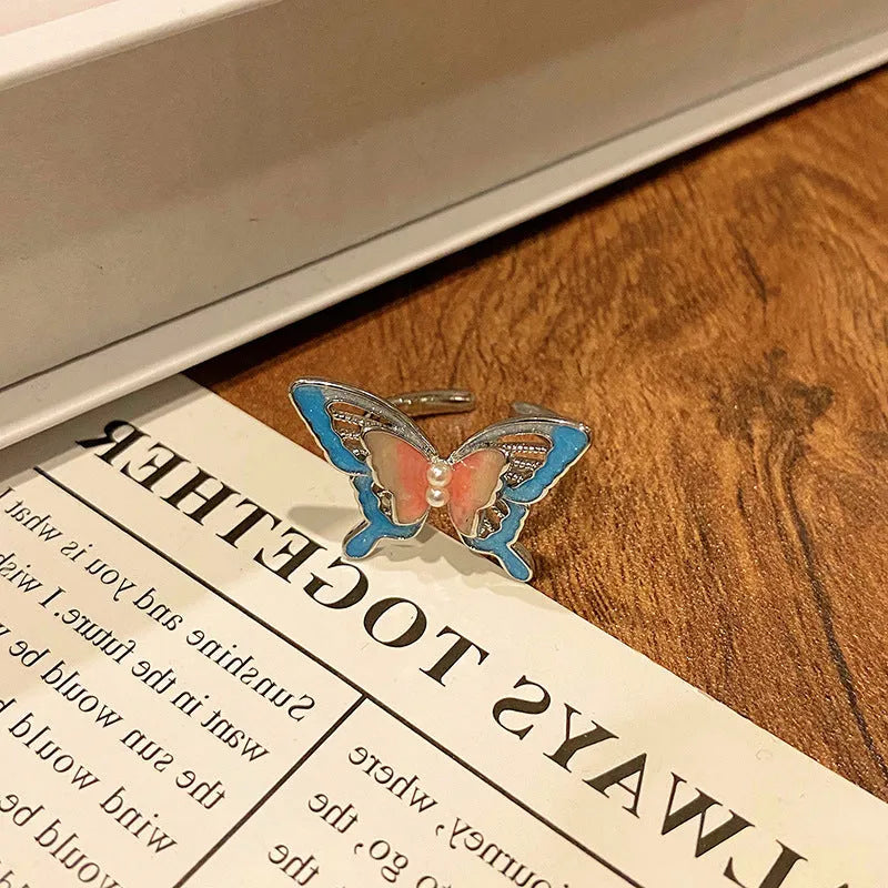 Copper women's ring with Chinese butterfly design and adjustable open loop.