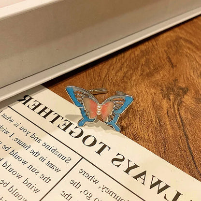 Copper women's ring with Chinese butterfly design and adjustable open loop.