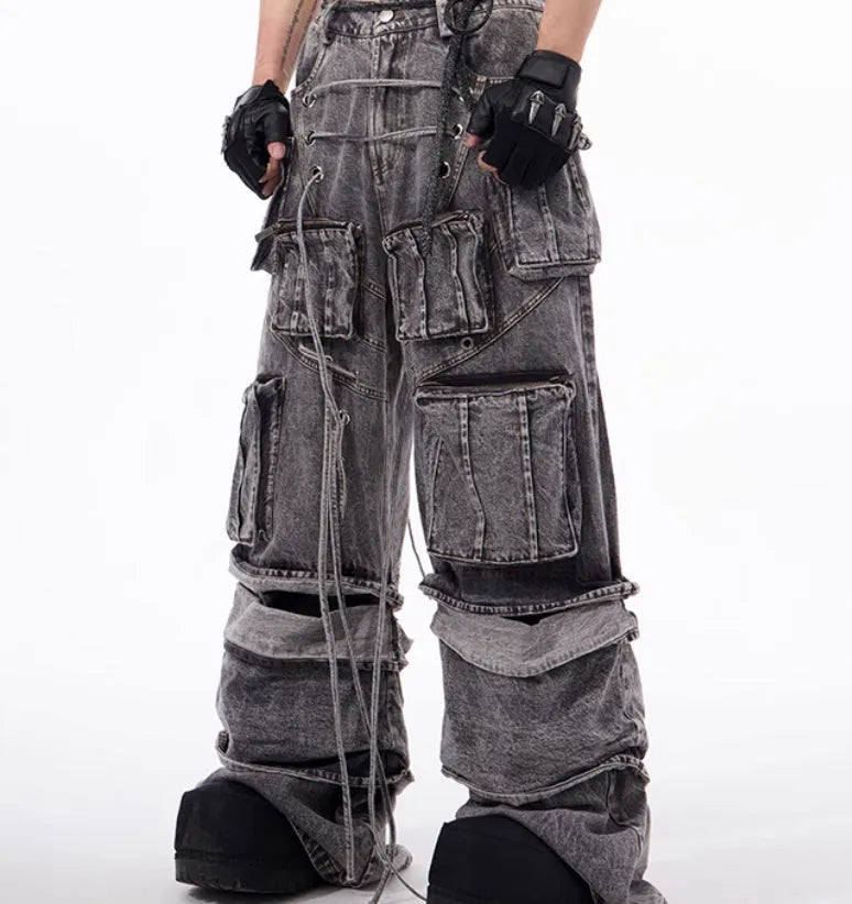 Grey distressed denim overalls with rope stitching on a man, showcasing the mop pant style.
