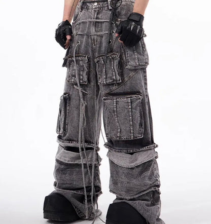 Grey distressed denim overalls with rope stitching on a man, showcasing the mop pant style.