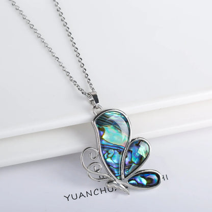 Abalone shell pendant necklace with copper electroplated animal zodiac design and butterfly or dragonfly detail