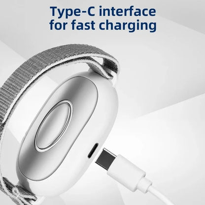 White handheld sleep aid remote control device with USB charging port on a bedside table.