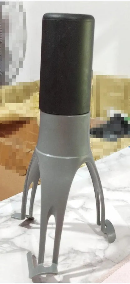 Uutensil Stirr automatic electric kitchen mixer device in green, shown next to a saucepan.