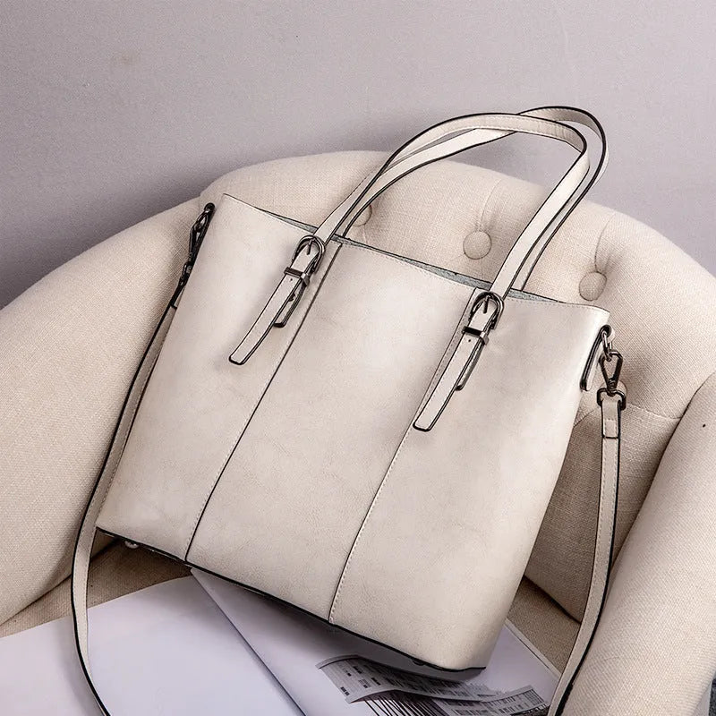 Brown genuine leather women's retro shoulder bag showing front view and organised interior pockets.