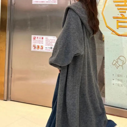 Women's Korean style hooded long knitted cardigan in oatmeal colour, showing loose fit and below-the-knee length
