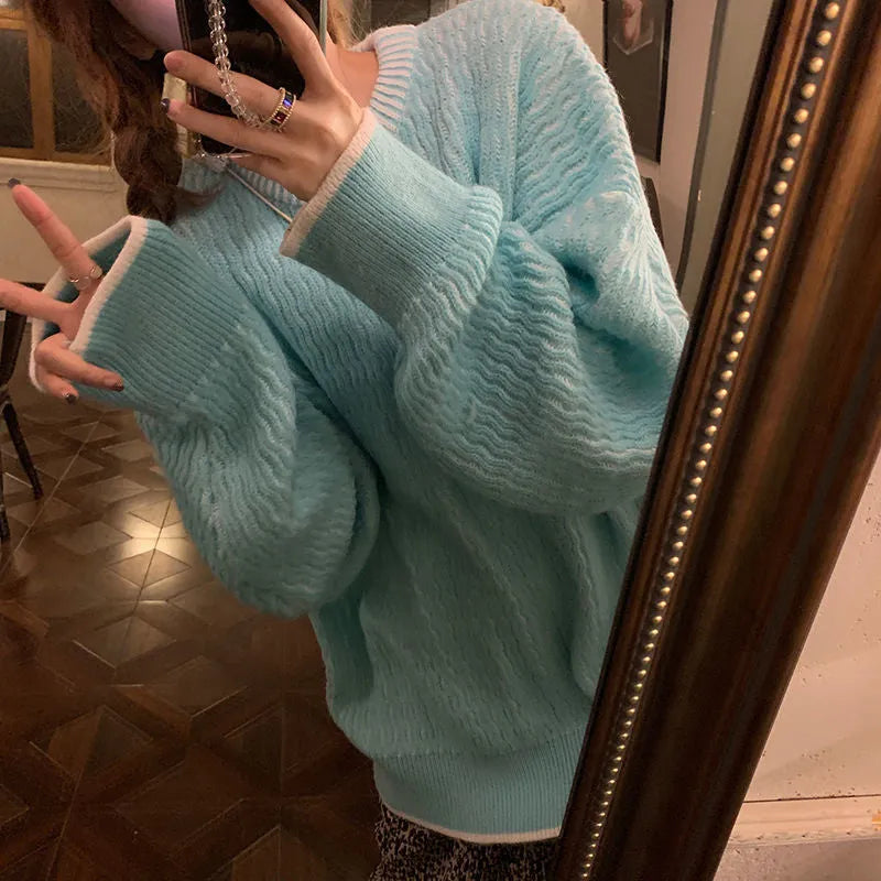 Women's loose blue pullover sweater with regular sleeves, shown on a hanger.