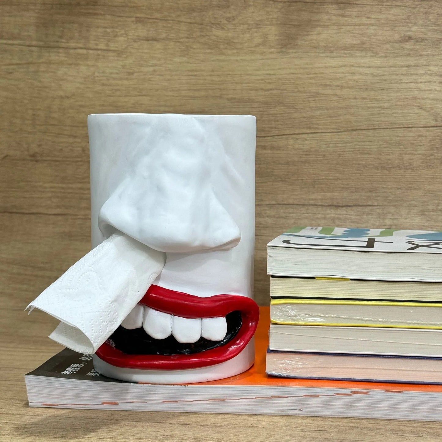 American-style solid resin tissue box holder in a funny design, measuring 8.5 by 14.6 centimetres, on a wooden desk.