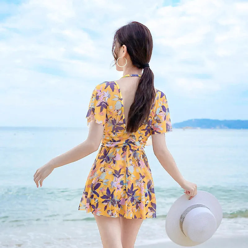 Yellow floral pattern women's one-piece swimsuit on hanger