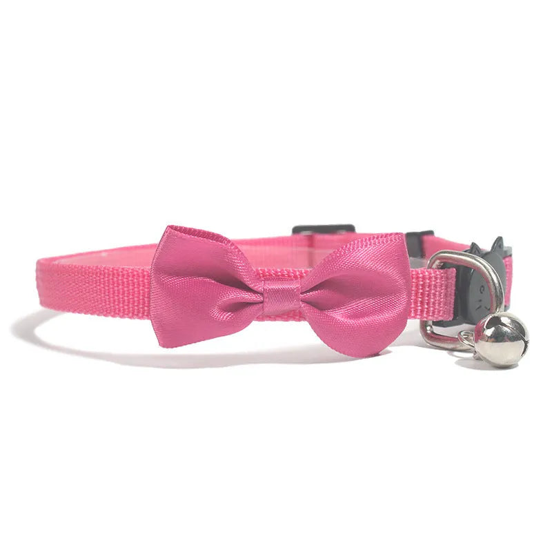 Striped nylon cat collar with decorative bow and bell in multiple colour options on a white background.