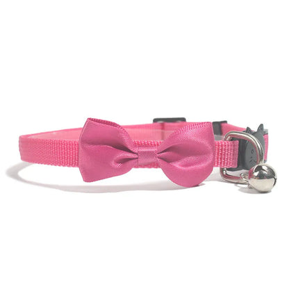 Striped nylon cat collar with decorative bow and bell in multiple colour options on a white background.