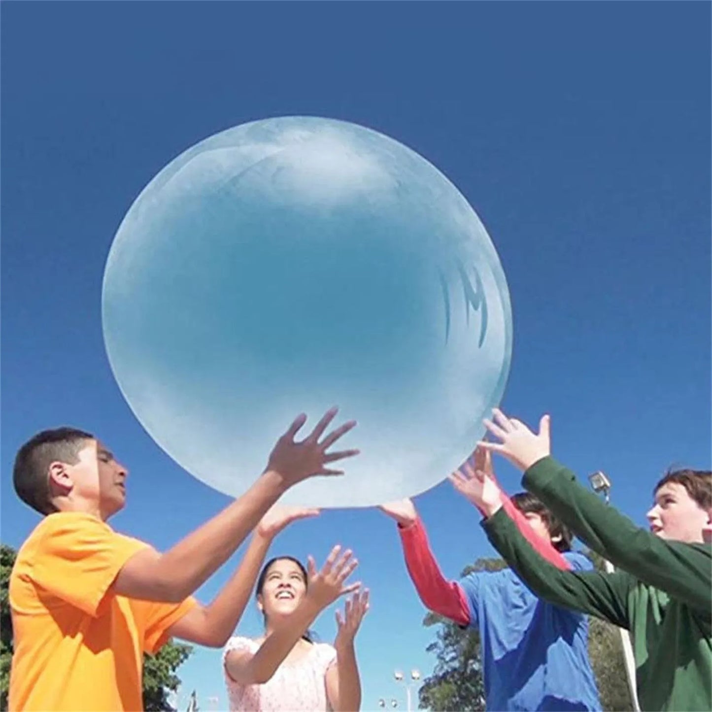 Large pink, yellow, green, and blue inflatable bouncy balls in various sizes for children's play.