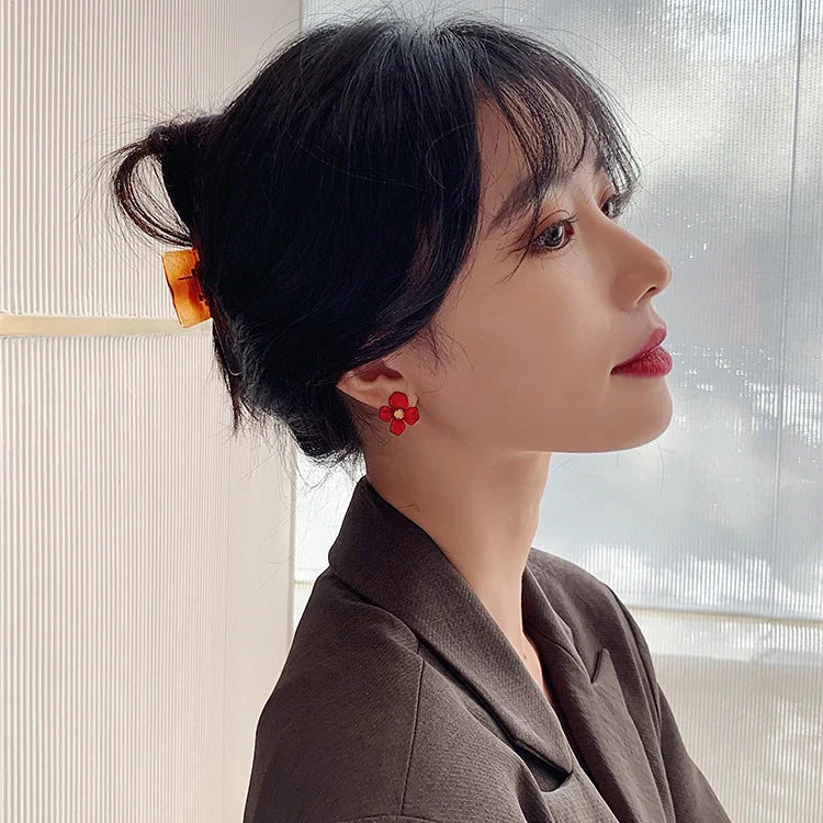 Silver-tone earrings with delicate red petal design, perfect for adding a touch of Korean-inspired elegance to any outfit.