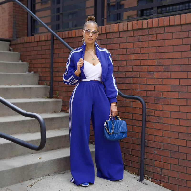 Street hipster two-piece suit with zipper detailing, striped or plaid pattern, and polyester fabric in sizes S-XXL for leisure and commute wear, available in grey, black, red, pink, green, and blue colours for a trendy, casual look.