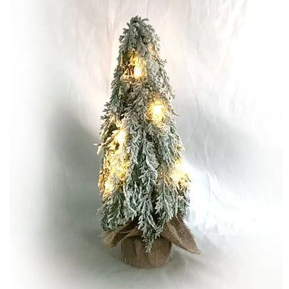 Compact 24-inch white pre-lit artificial Christmas tree with snow-covered branches on a table.
