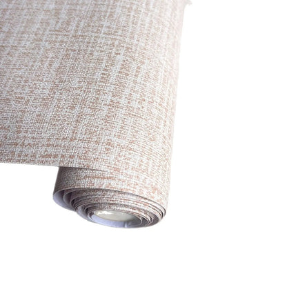 Roll of beige linen self-adhesive wallpaper with textured finish next to a sample applied to a clean white wall.