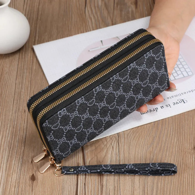 Long black retro-style PU leather wallet clutch with a printed pattern, showing a mobile phone pocket and a zippered coin purse.