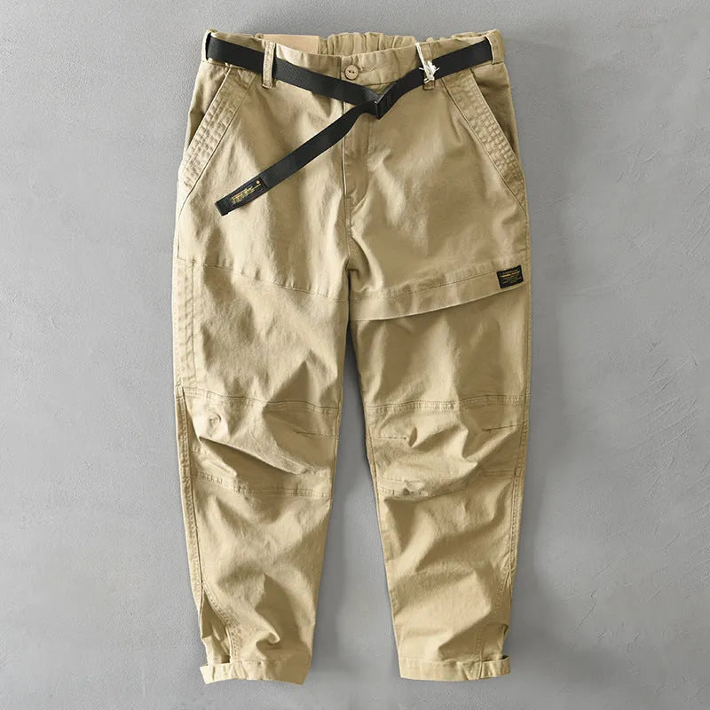 Man wearing khaki-coloured loose-fit cotton casual overalls with an elastic waist.