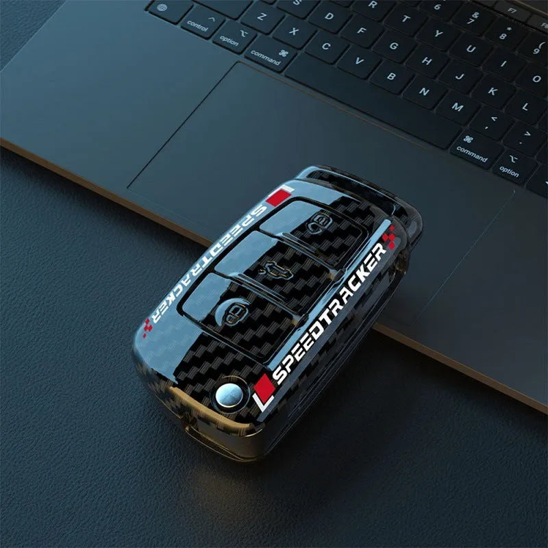 Carbon fibre style car key cover with a mirrored surface element, shown in black and white.