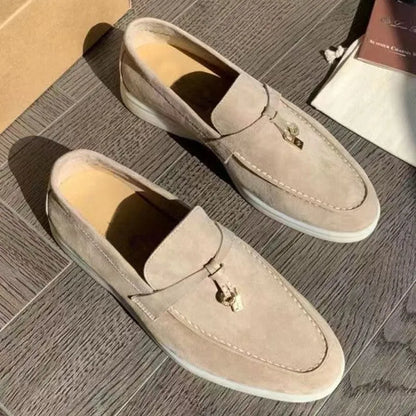 High top slip-on loafers in black with round toe and sewing line detail on a rubber sole.