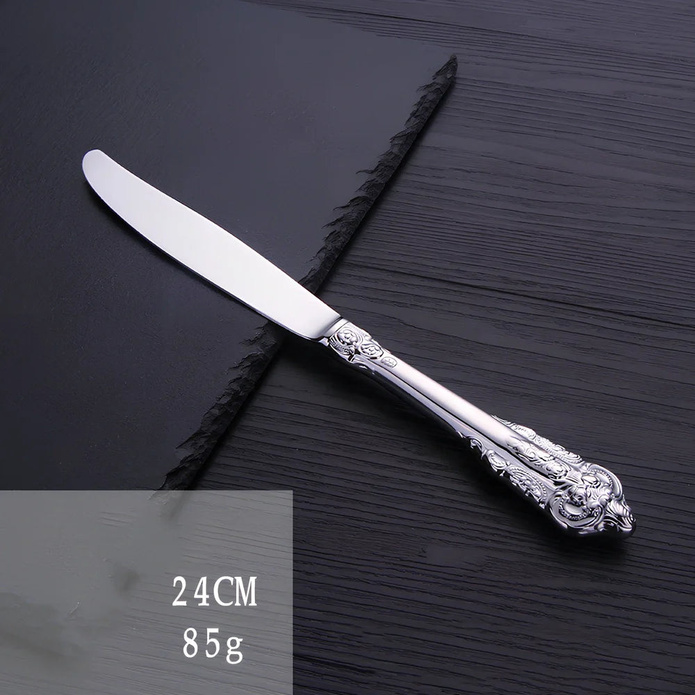 Four-piece stainless steel cutlery set showing main knife, fork, spoon, and teaspoon with mirror finish